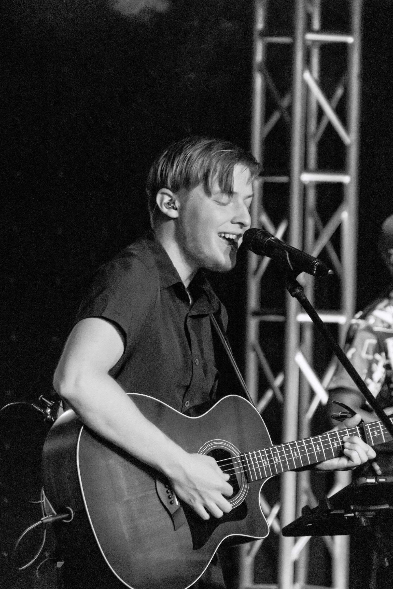Trevor singing with acoustic guitar